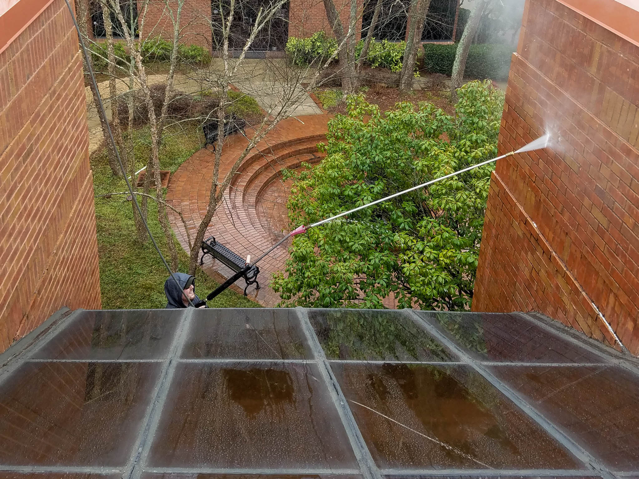 Photo of Penson Pressure Washing team member performing hot & cold pressure washing services in Marietta, GA