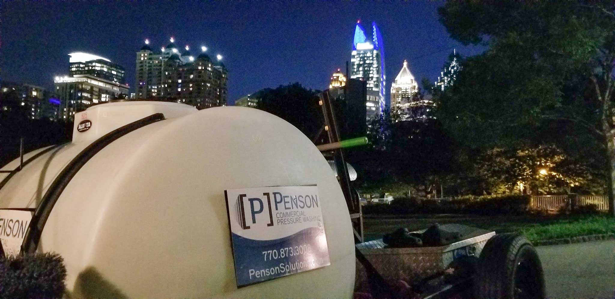 Photo of a Penson Pressure Washing truck in front of an Atlanta skyline at night